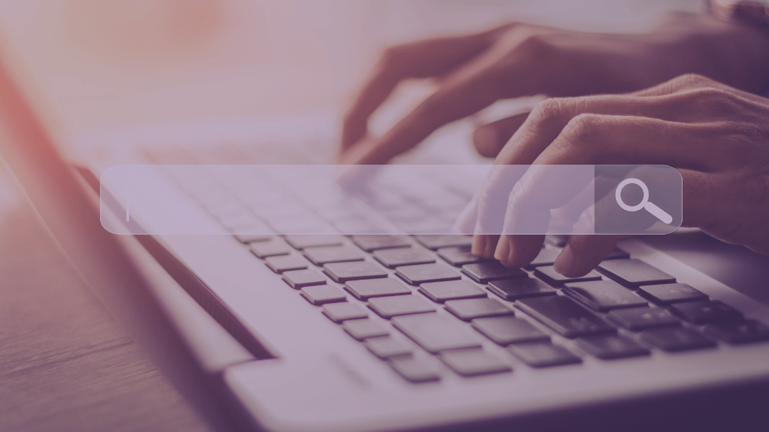 Hands poised over keyboard with search bar in foreground.